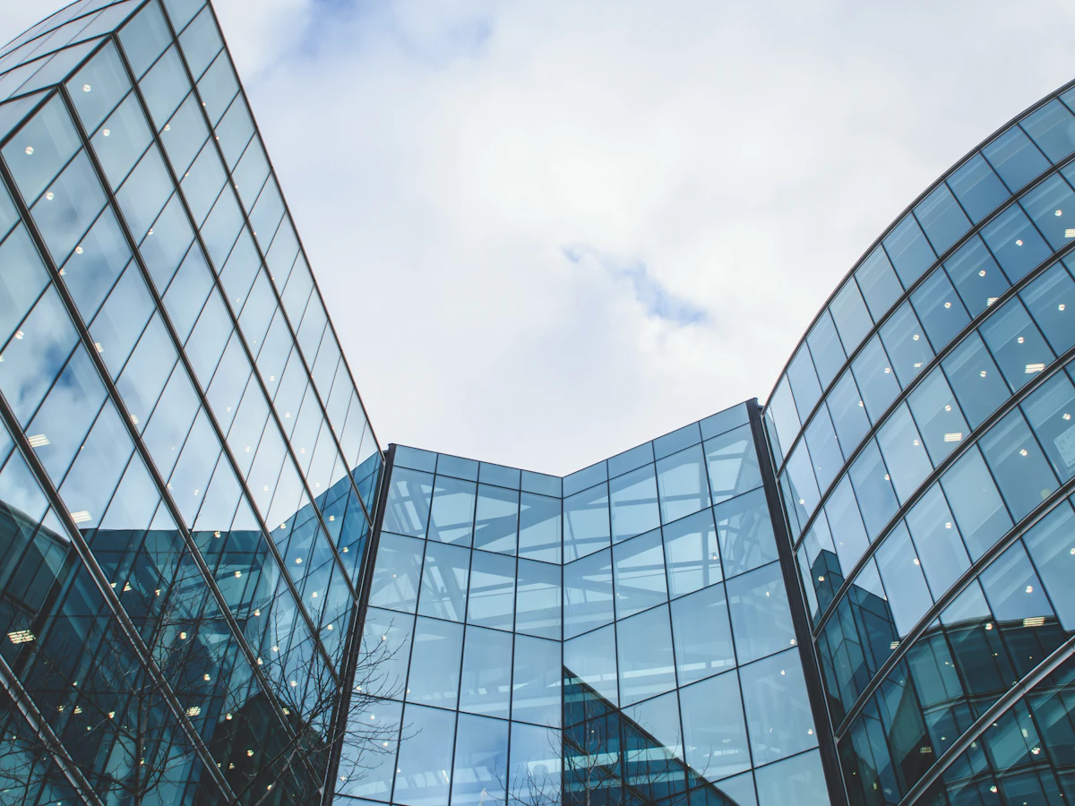 Modern high-rise buildings viewed from below against a clear sky